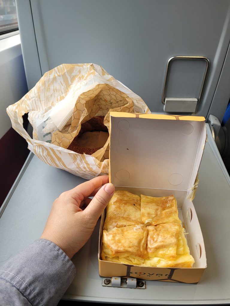 Enjoying borek and simit I bought at a local bakery before boarding the train